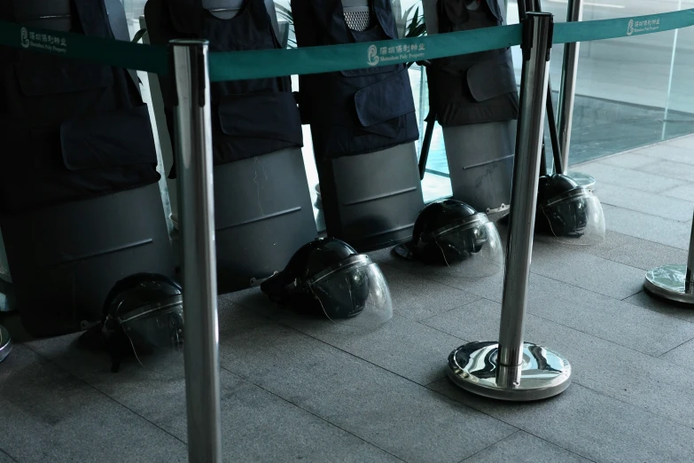 many people are lined up waiting for their baggage to come off