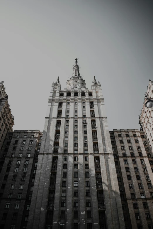 the building looks very tall and there is a large clock on the front