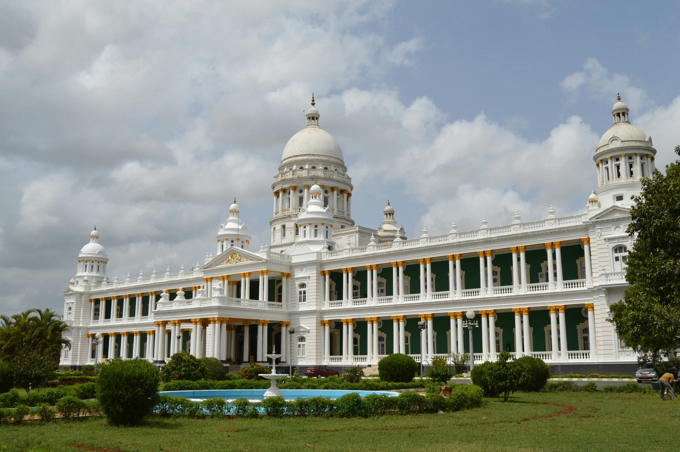 large building on a cloudy day in front of a pond