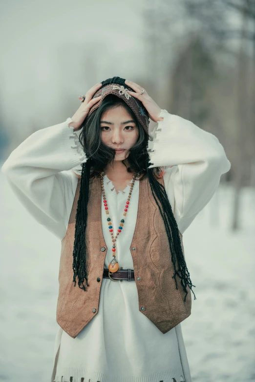 an asian woman posing in the snow with her hair up