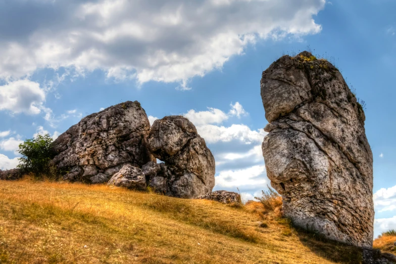 some very large rocks on a grassy hill