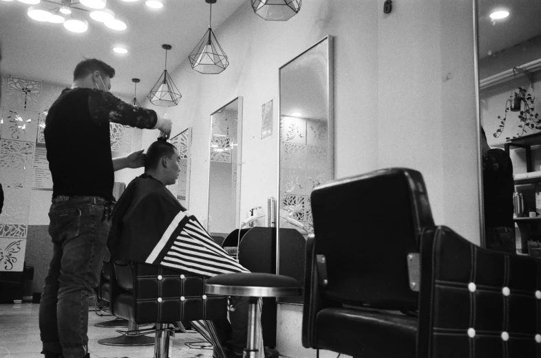 a man getting his hair cut in a salon