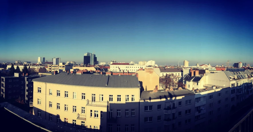 a panorama of buildings with a blue sky in the background