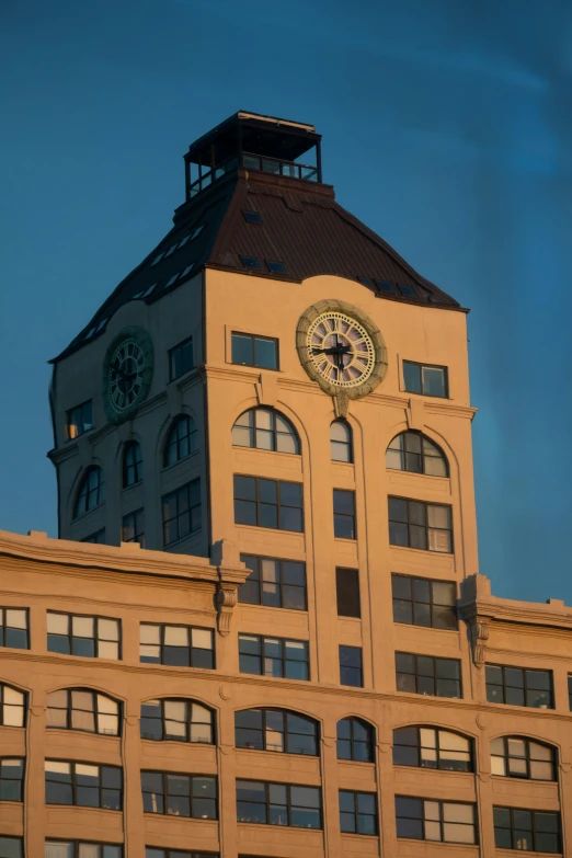 the top of a large building has a clock on it