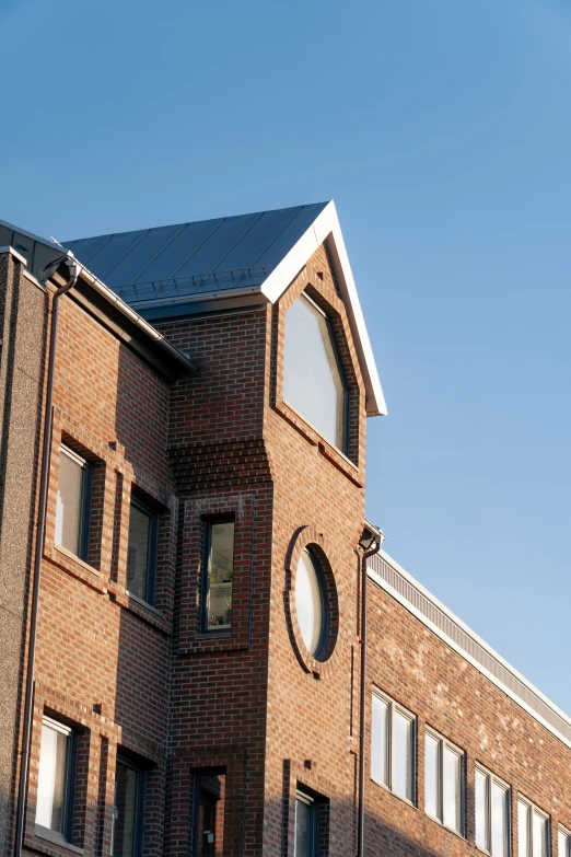 the roof of a building has three windows