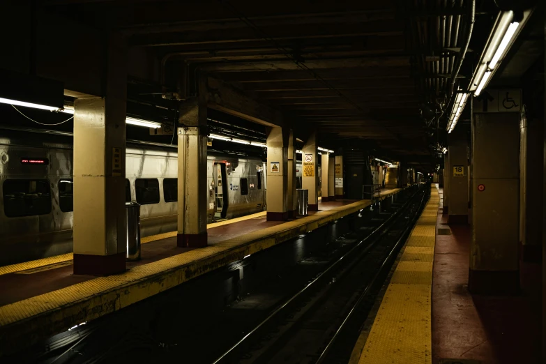 an empty subway platform in the dark with no people