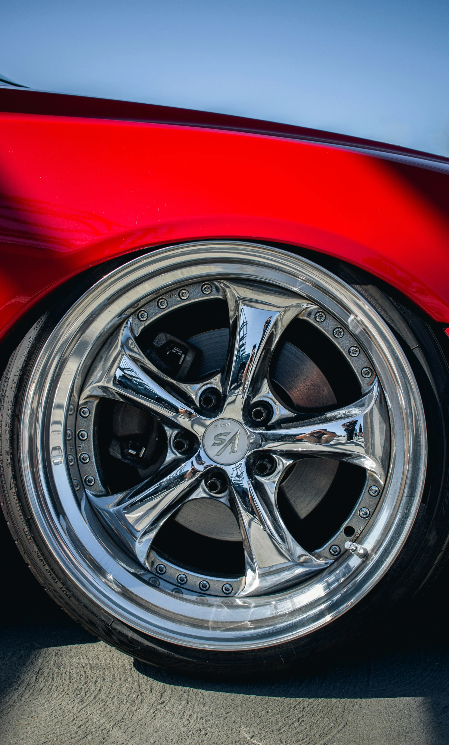 a close up of a car tire on a red vehicle