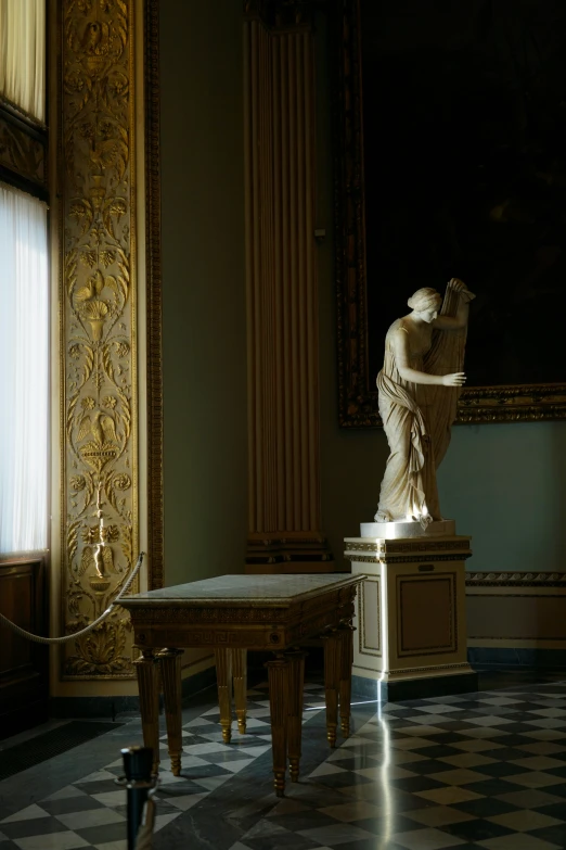 the statue is standing on top of a marble table