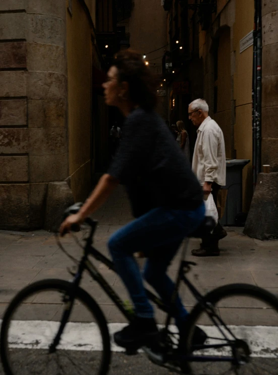 an older gentleman riding his bicycle down the street