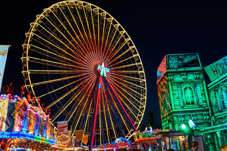 a large colorful ferris wheel in the middle of the city