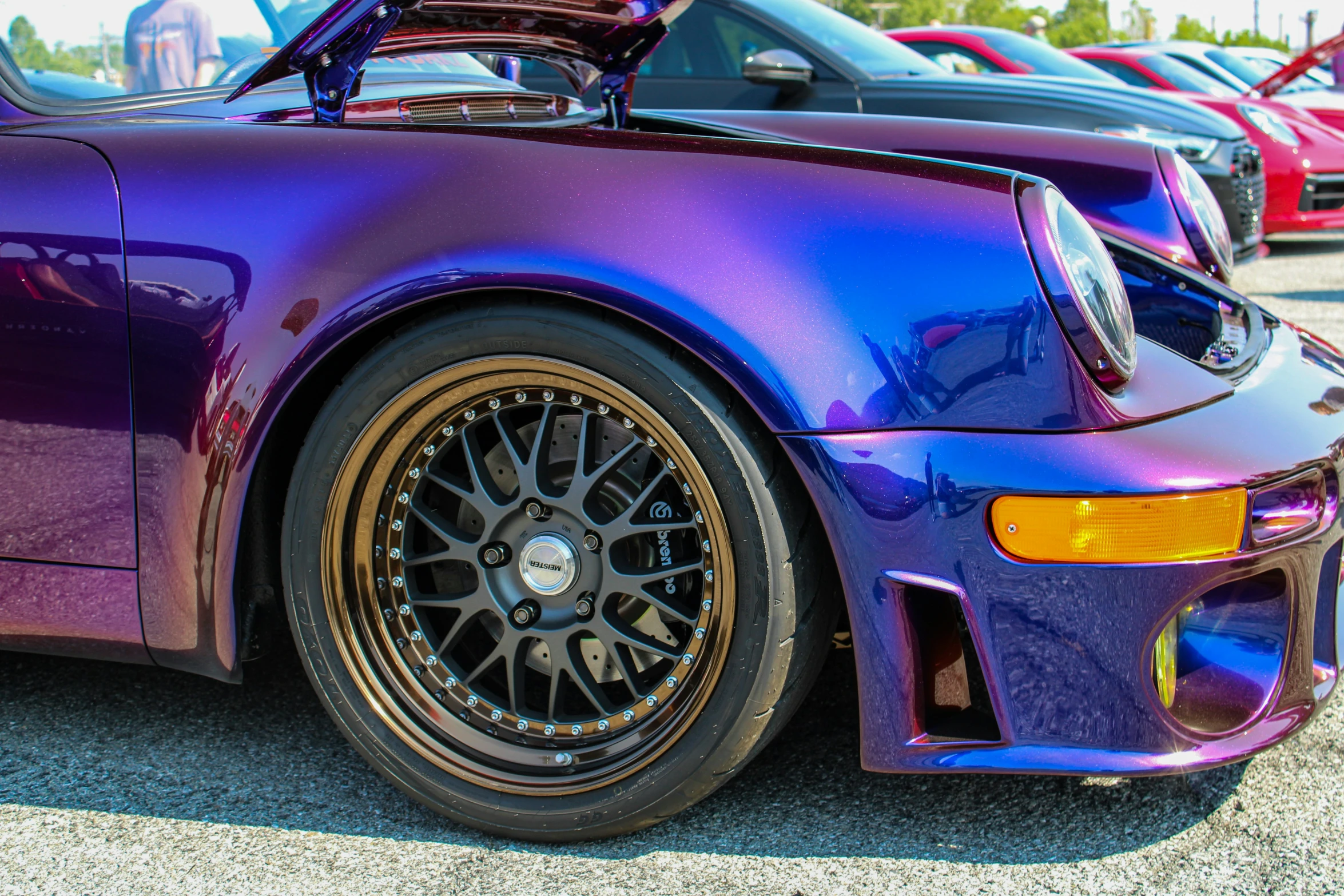 a purple and blue sports car in a parking lot