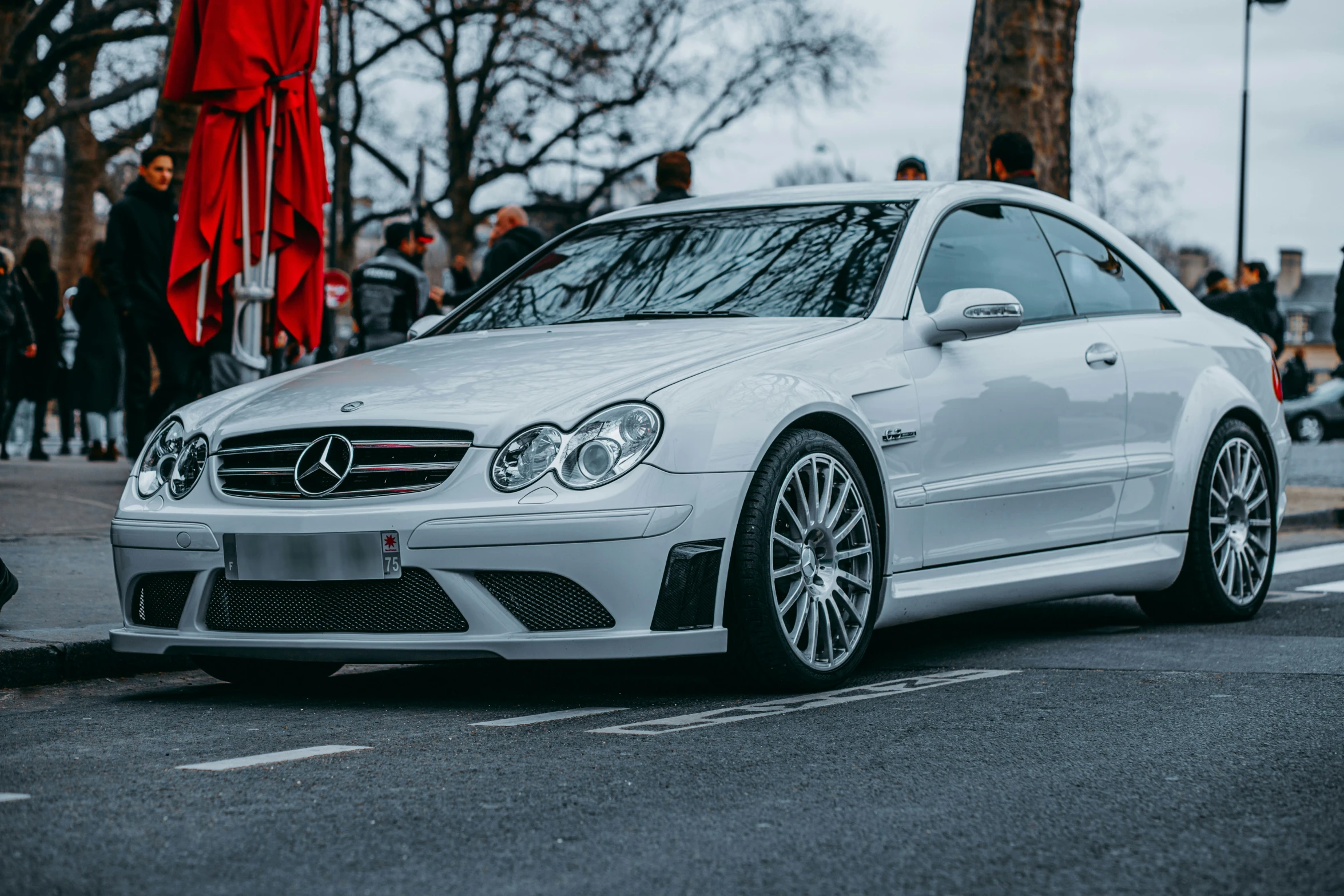 a mercedes cls parked on the side of the road