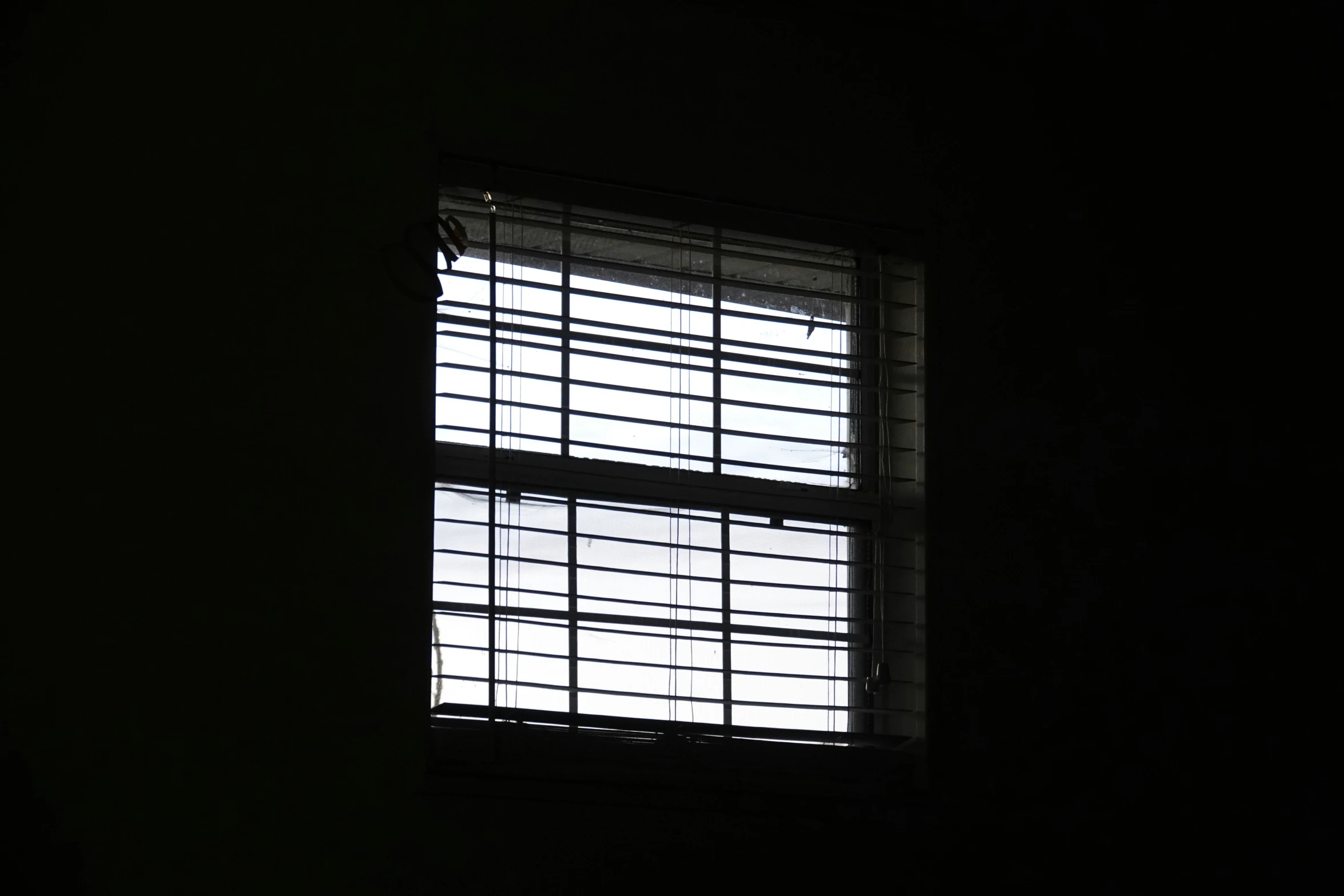 a window with a lot of blinds next to it