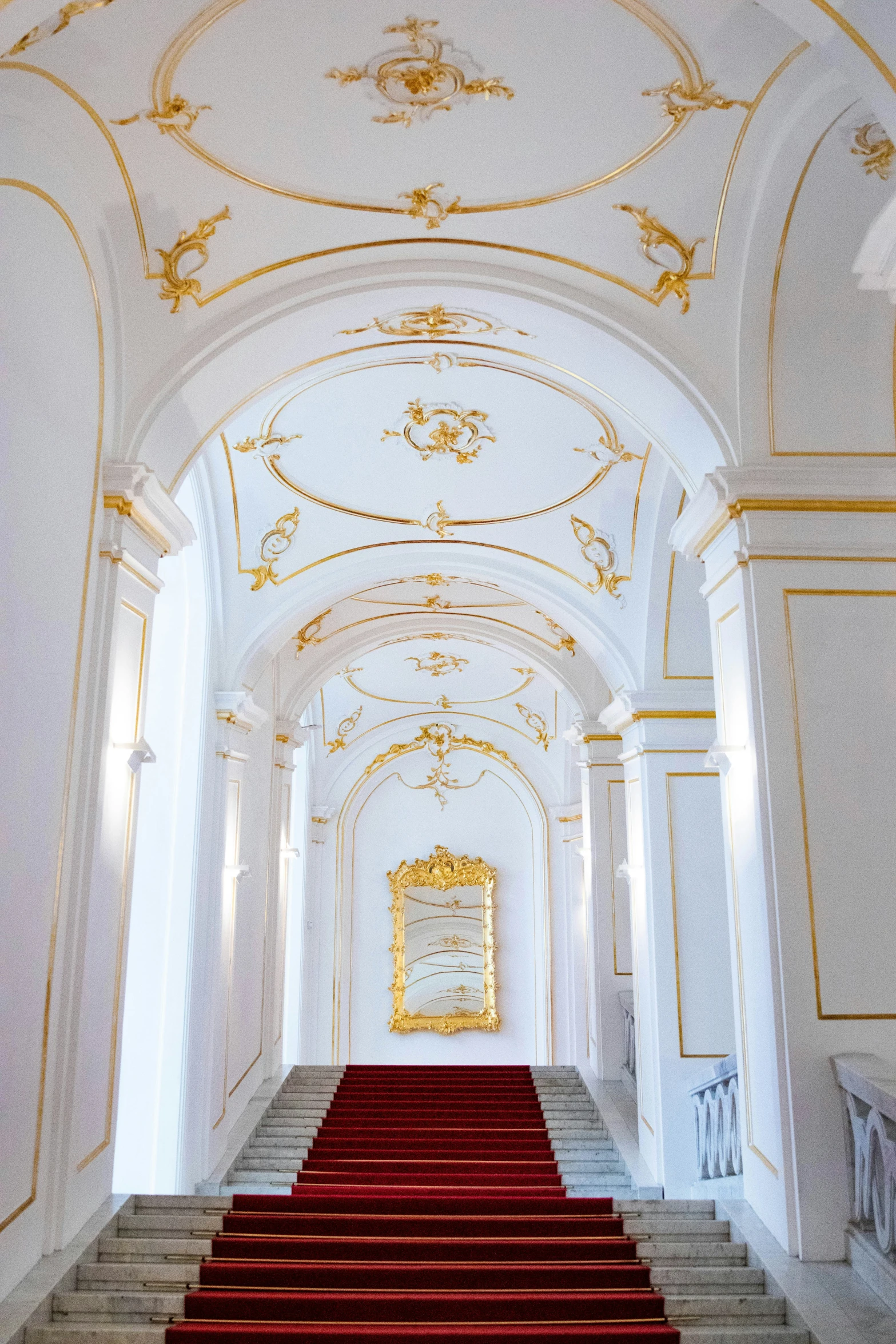 several steps leading up to an archway and golden ceiling