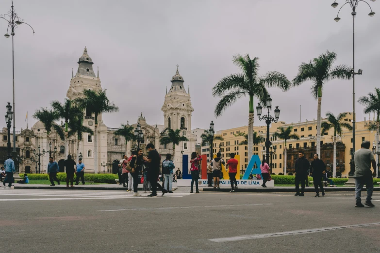 people walking through an area in front of a building