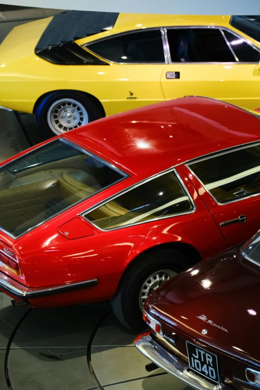 vintage cars in an automobile museum, parked next to each other