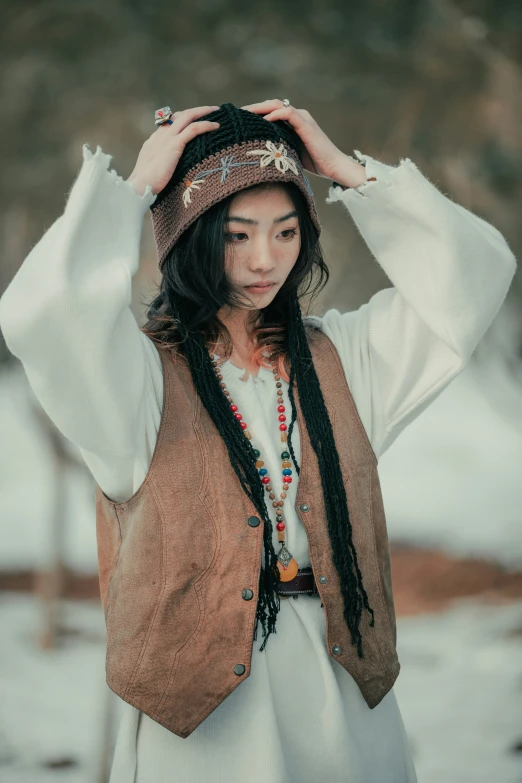 a woman wearing a hat and a scarf on her head