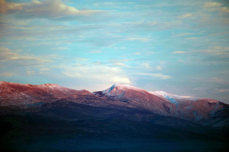 snow covered mountains under a blue sky during the day