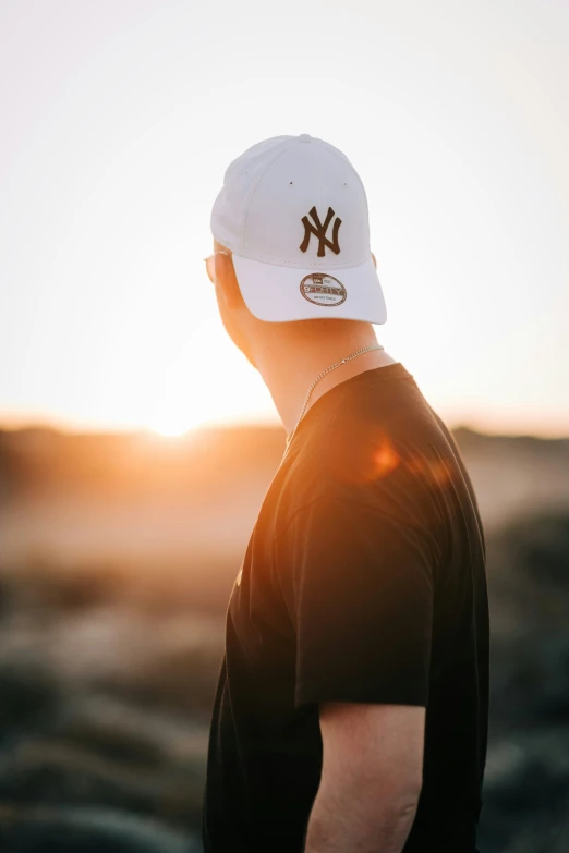 a man wearing a hat and sun in the background