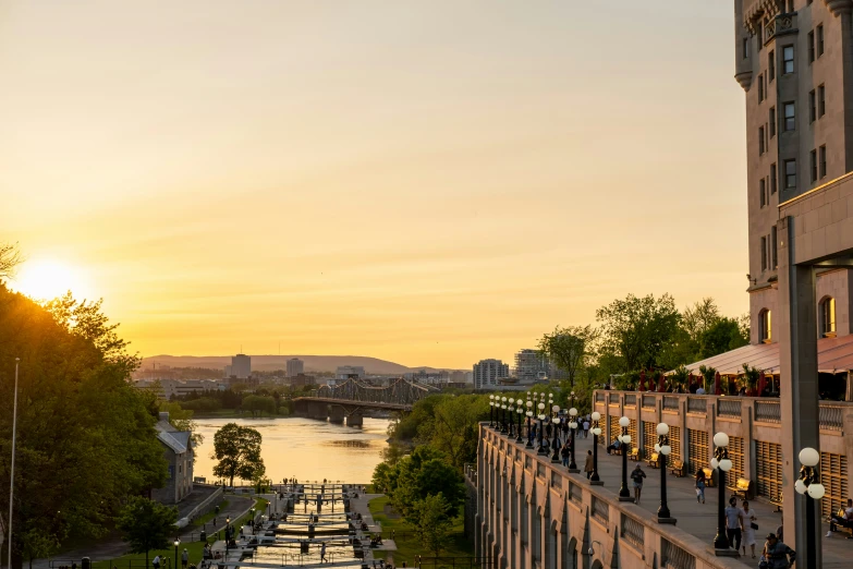 a large balcony on a building overlooking water and sunset