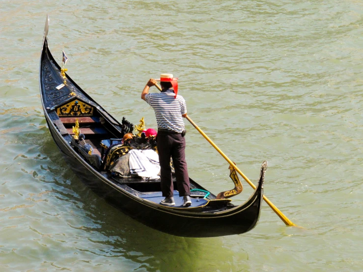 a man riding in a gondola on top of water