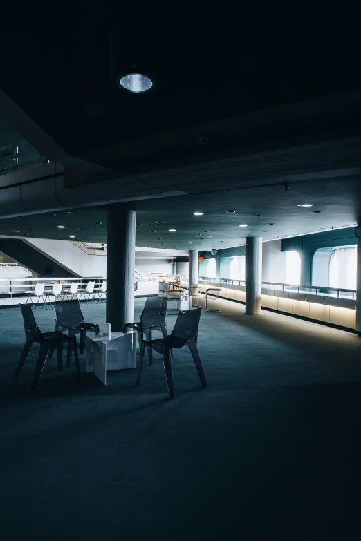 the interior of a restaurant with high tables and chairs