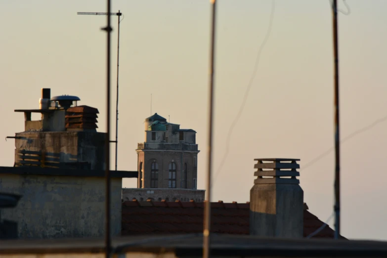 some buildings with rooftops and a few chimneys