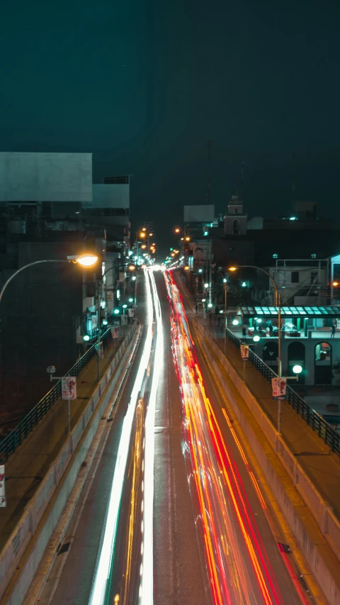 an intersection that contains highway and city with blurred traffic