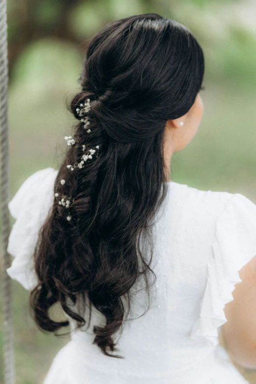 a woman that has long hair with a flower in her hair