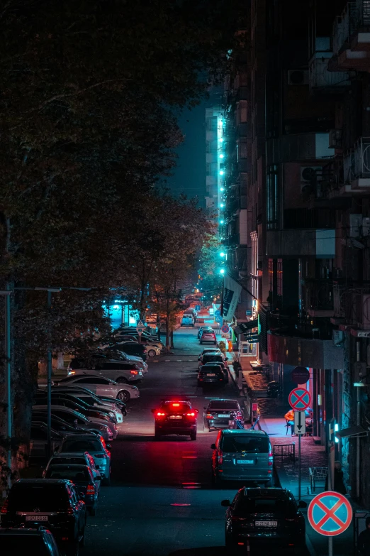 a city street at night with all lit up