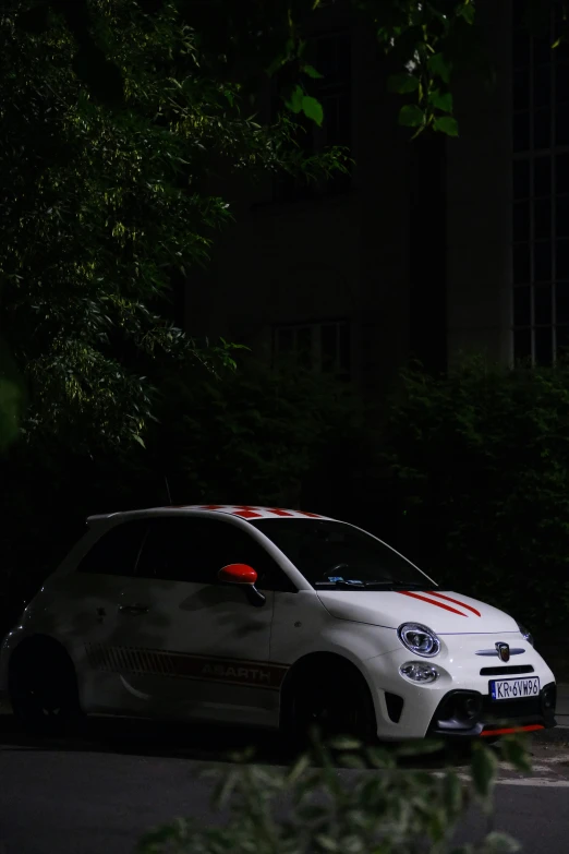 a white car is parked in front of a building