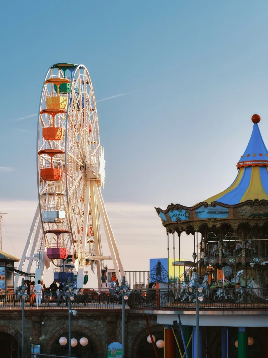 a carnival with ferris wheel and various rides on top