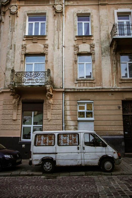 an old van parked next to an older building