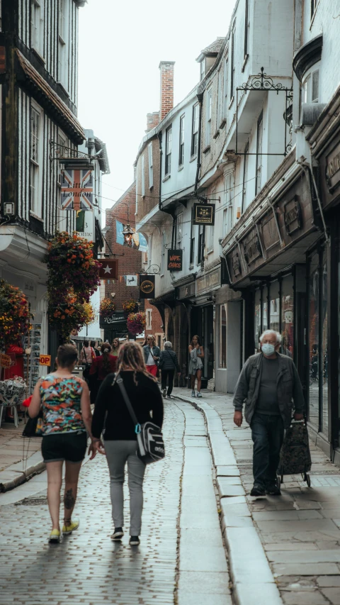 two people are walking down the street while two others walk in the distance