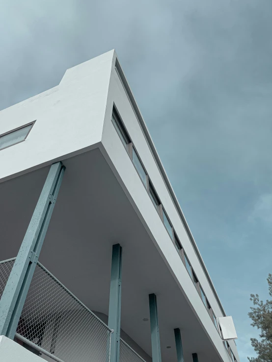 a large white building with many windows and a sky background