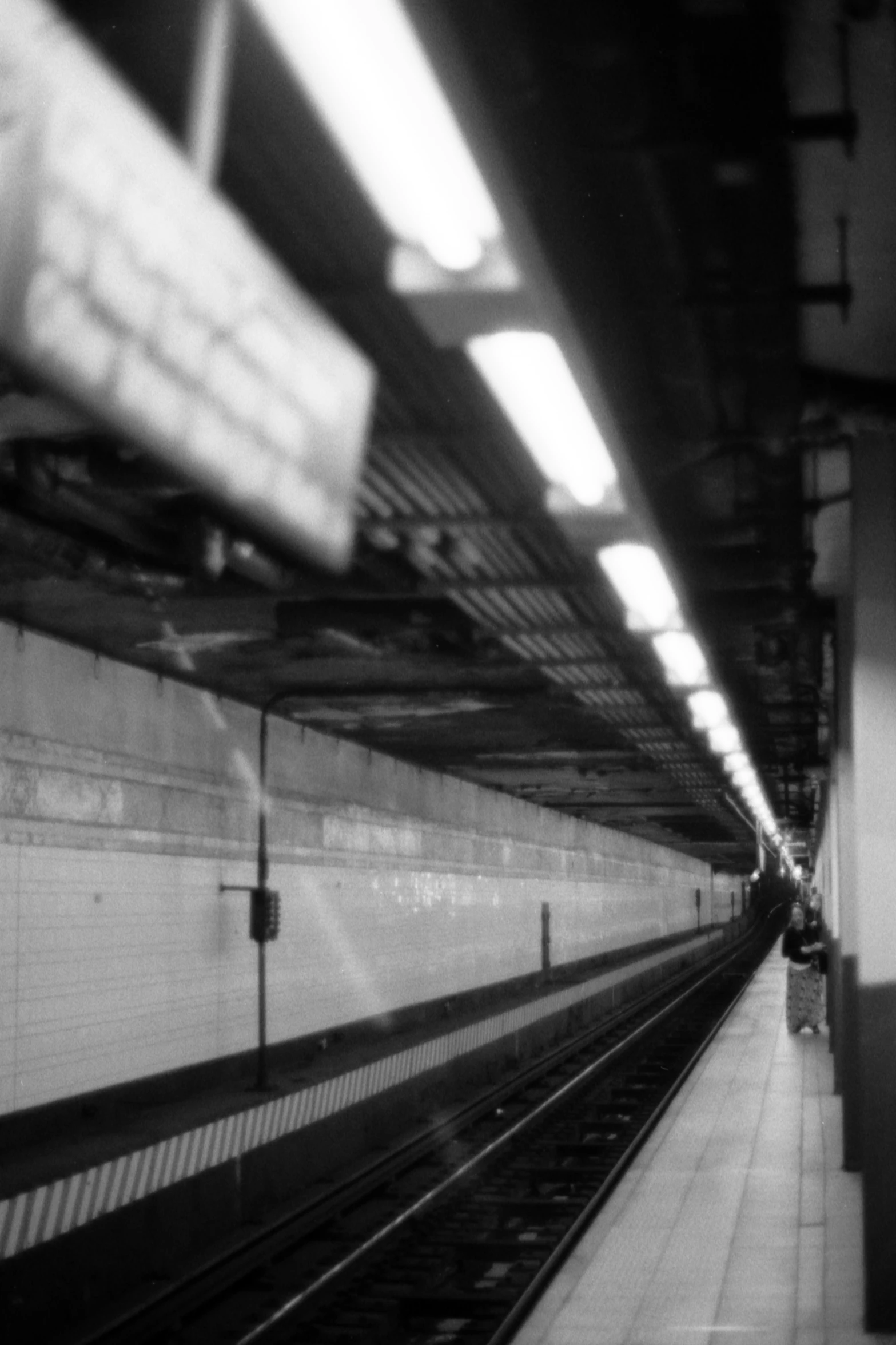 the lights shine from the subway train at the station