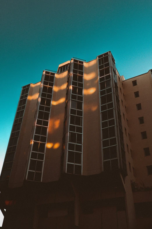 a tall building with windows is lit up