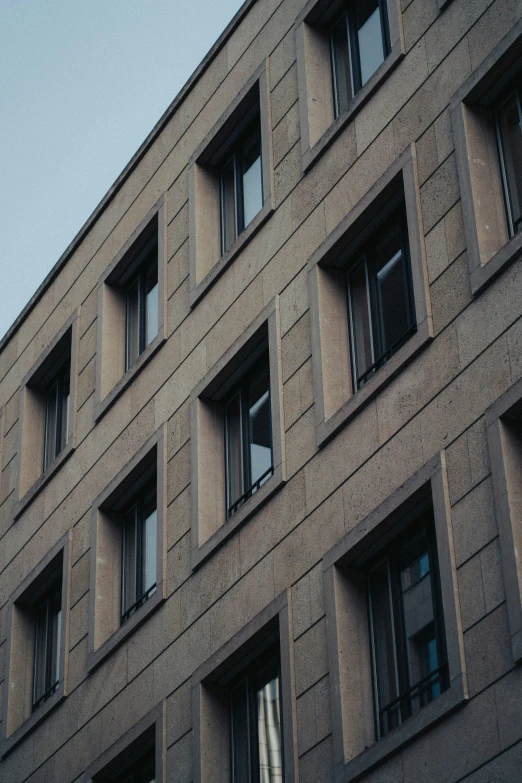 an exterior s of windows on a tall, stone building