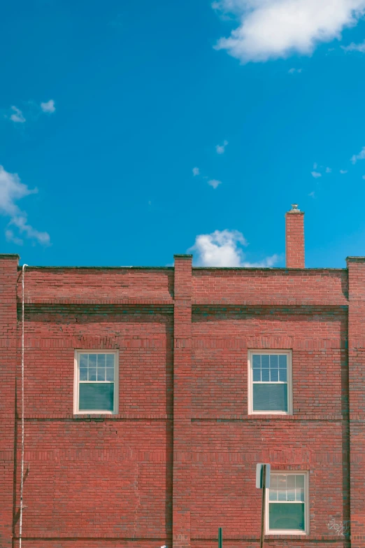 a tall brick building with a street light on a corner