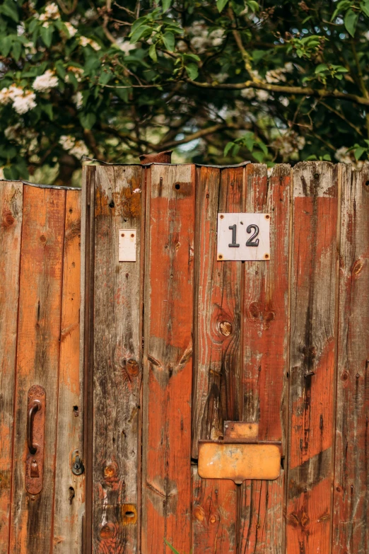 a wooden gate with a number eleven hanging on it