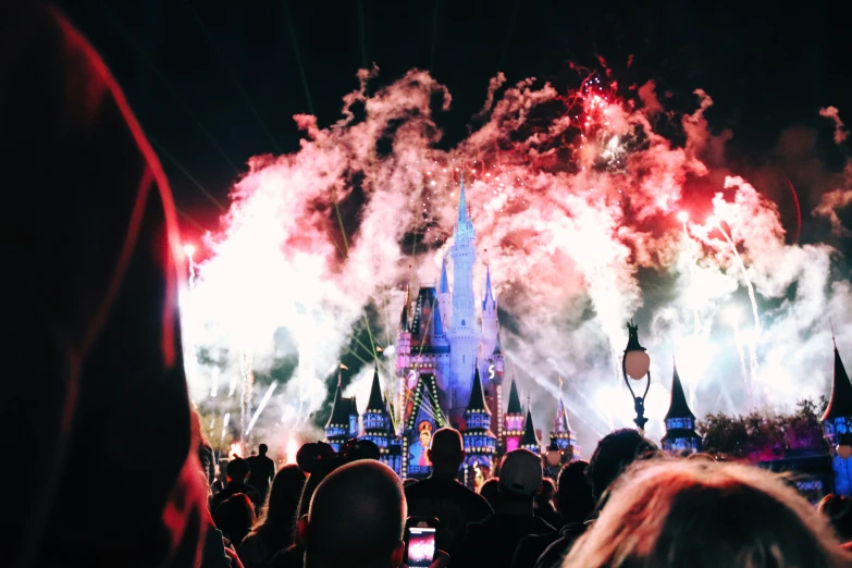 a group of people standing in front of a castle