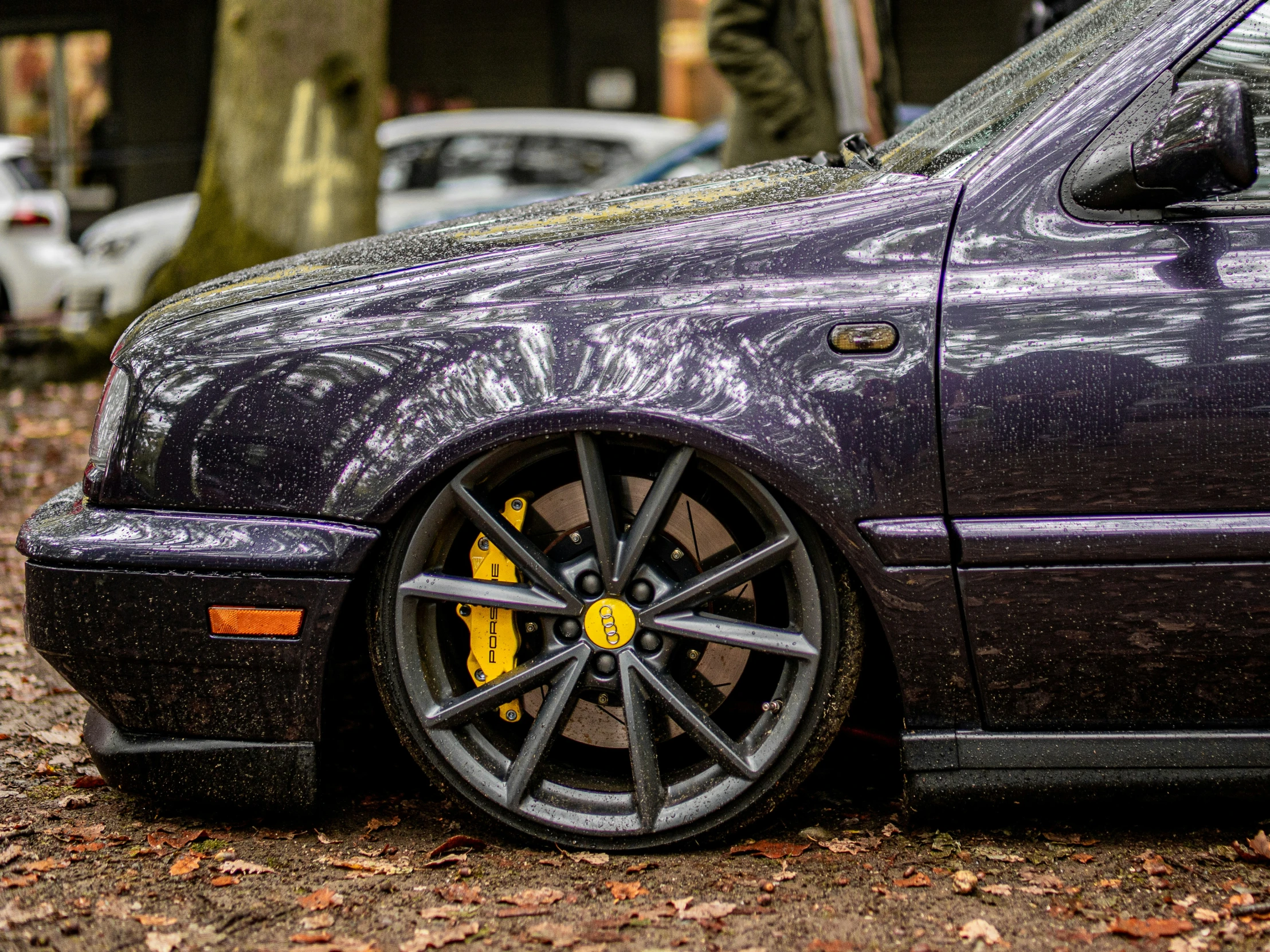 an image of a purple car parked in the rain