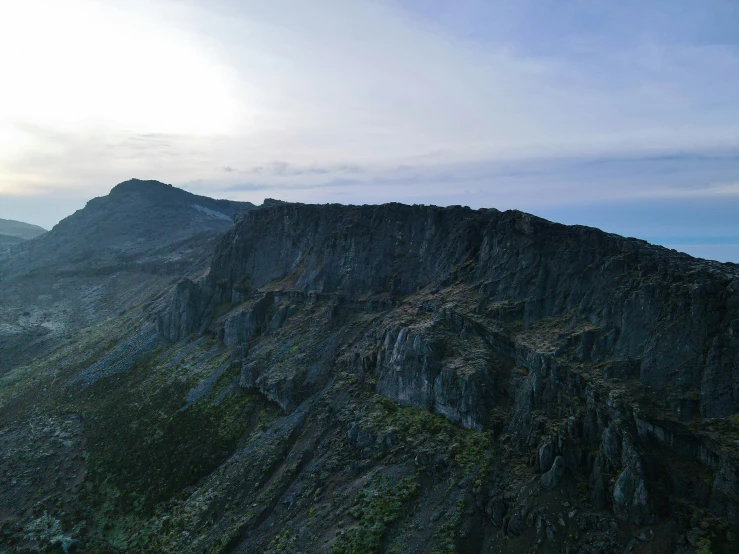 a scenic po of a mountain ridge with the sun shining on it