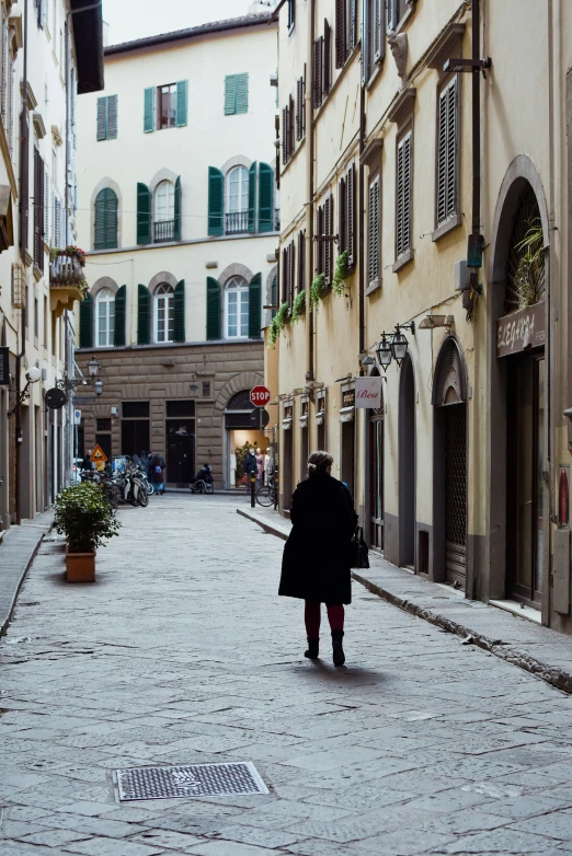 a woman is walking through an empty street