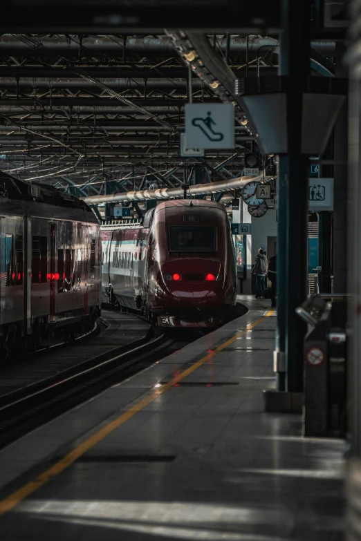 two trains are traveling next to each other at the station