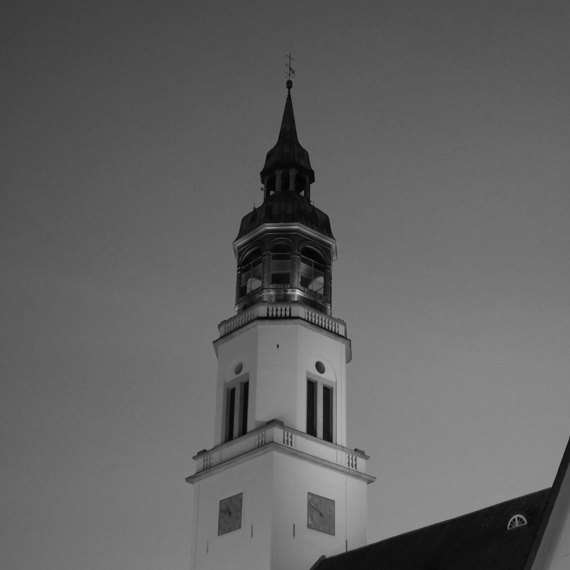 there is a black and white po of a church steeple