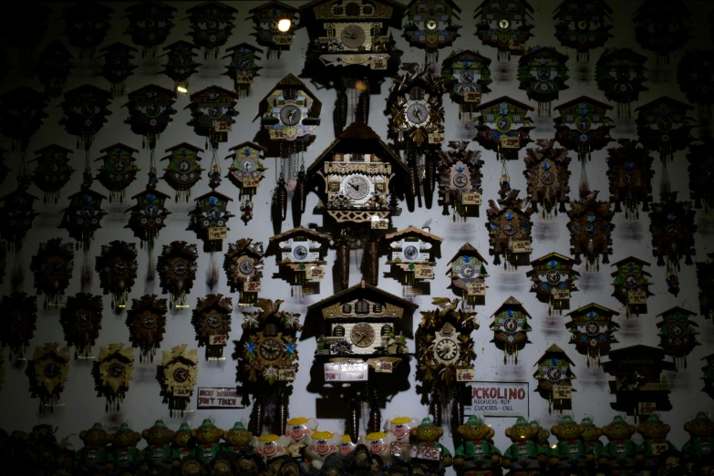 a very large wall with some unique clocks on it