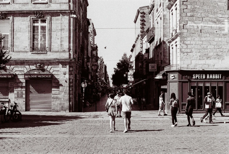 a street scene with people walking and some buildings