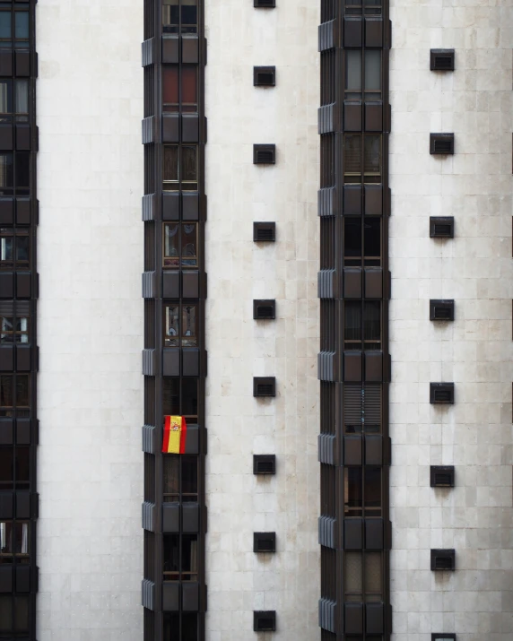 windows in the building with red and yellow kite