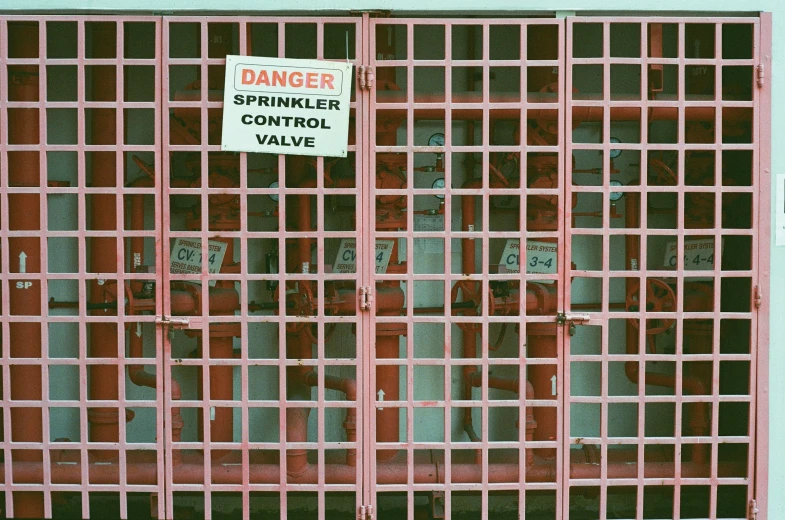 a red gate with a sign that reads danger